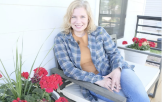Nicole Tysvaer, CEO of Symbi Homes on the porch of Duplex One